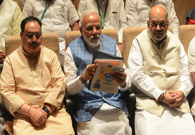 (L-R) BJP working president J P Nadda, Prime Minister Narendra Modi and Home Minister Amit Shah
