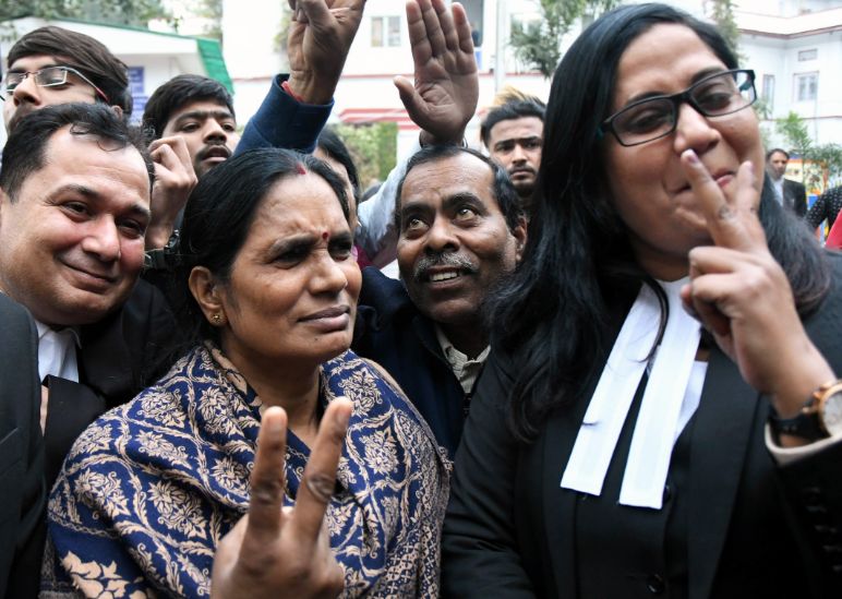 flash the victory sign after the court issued death warrants