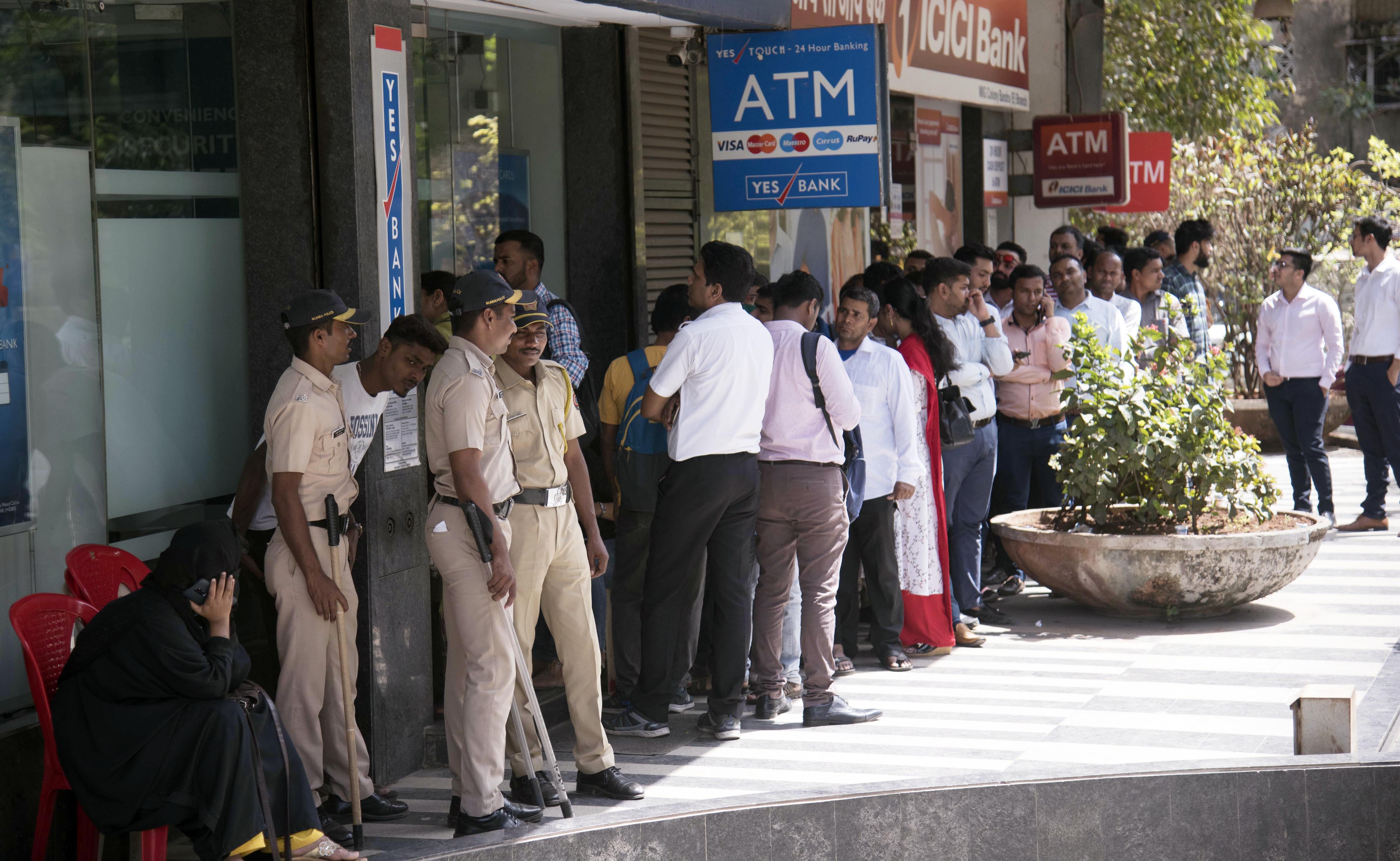 Yes Bank Crisis: Account holders stand in a queue to withdraw money | See Pics