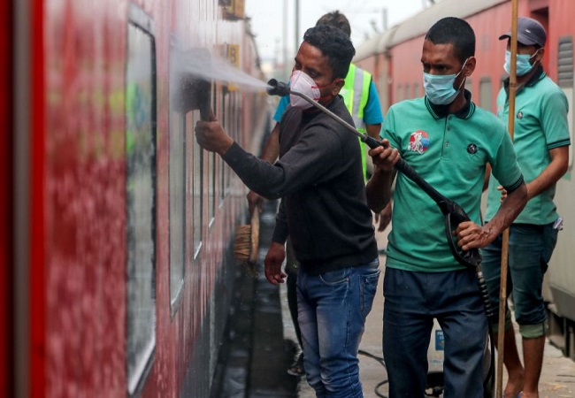 Railway workers clean coaches as a preventive measure against COVID-19 , coronavirus