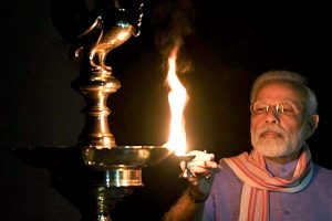 PM Modi lights a lamp after turning off all lights at his residence | See Pics