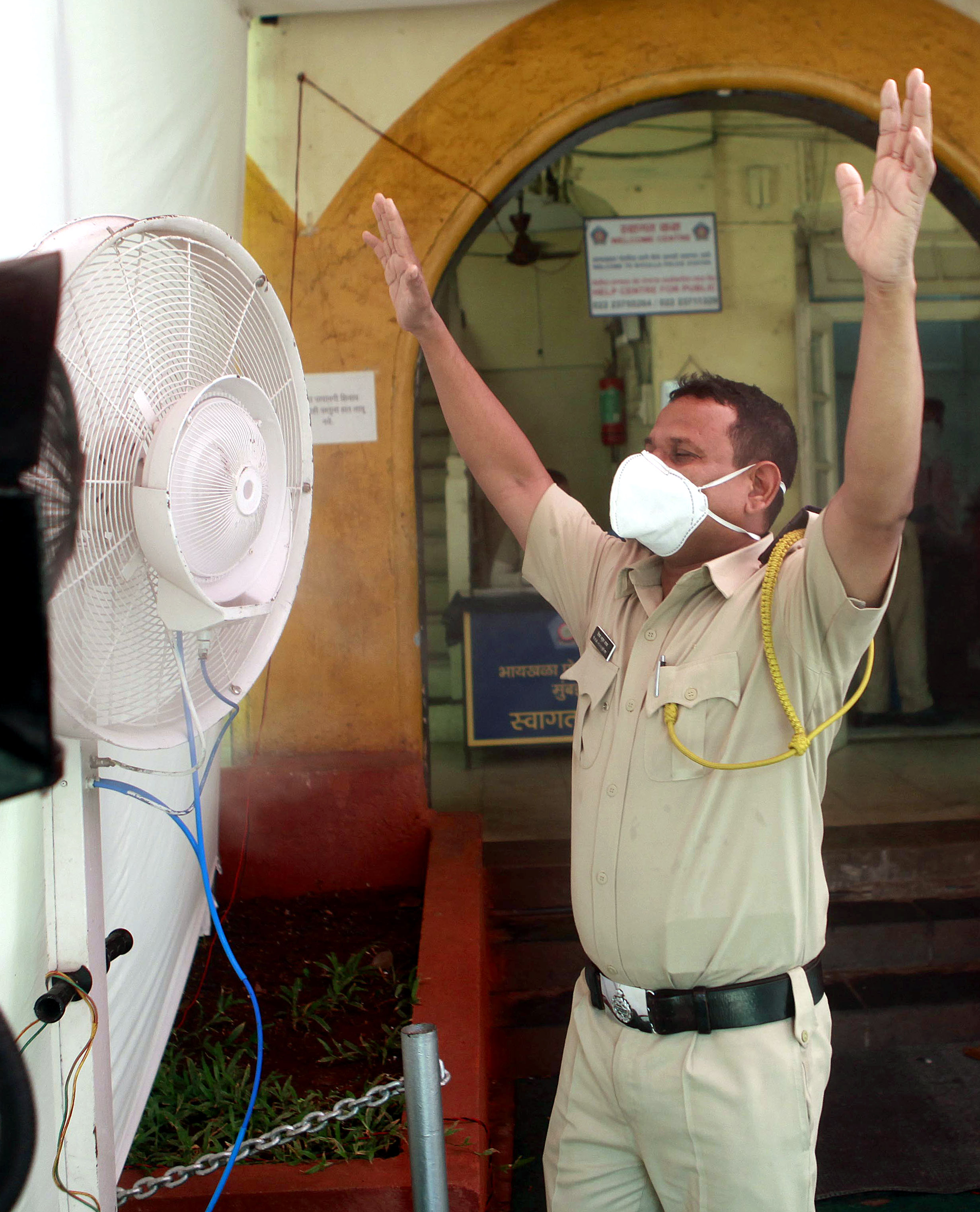 Police personnel sanitize themselves infront of mist spray fans | See Pics
