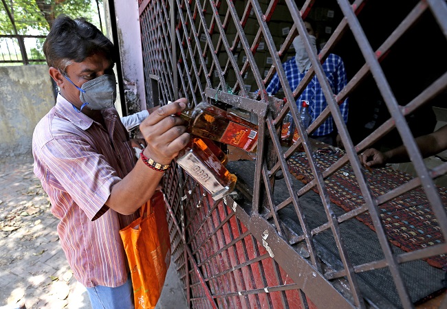 Long queues, crowds continue at liquor shops in Delhi despite tax hike