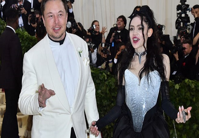Amid reports of troubled relationship, singer Grimes says still living with Elon Musk
