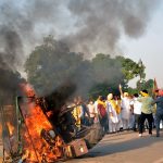 Punjab youth congress workers set ablaze a tractor during a protest