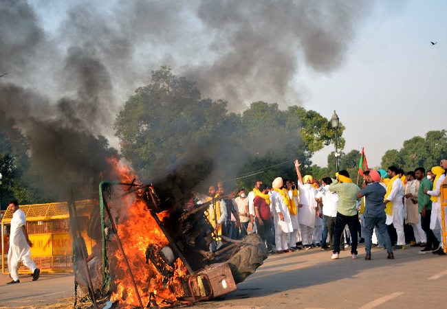 Punjab youth congress workers set ablaze a tractor during a protest