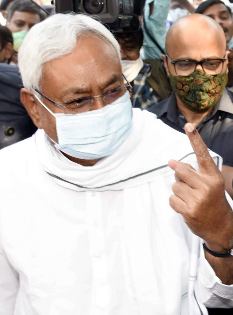 Bihar Chief Minister Nitish Kumar shows finger marked with indelible ink after casting his vote