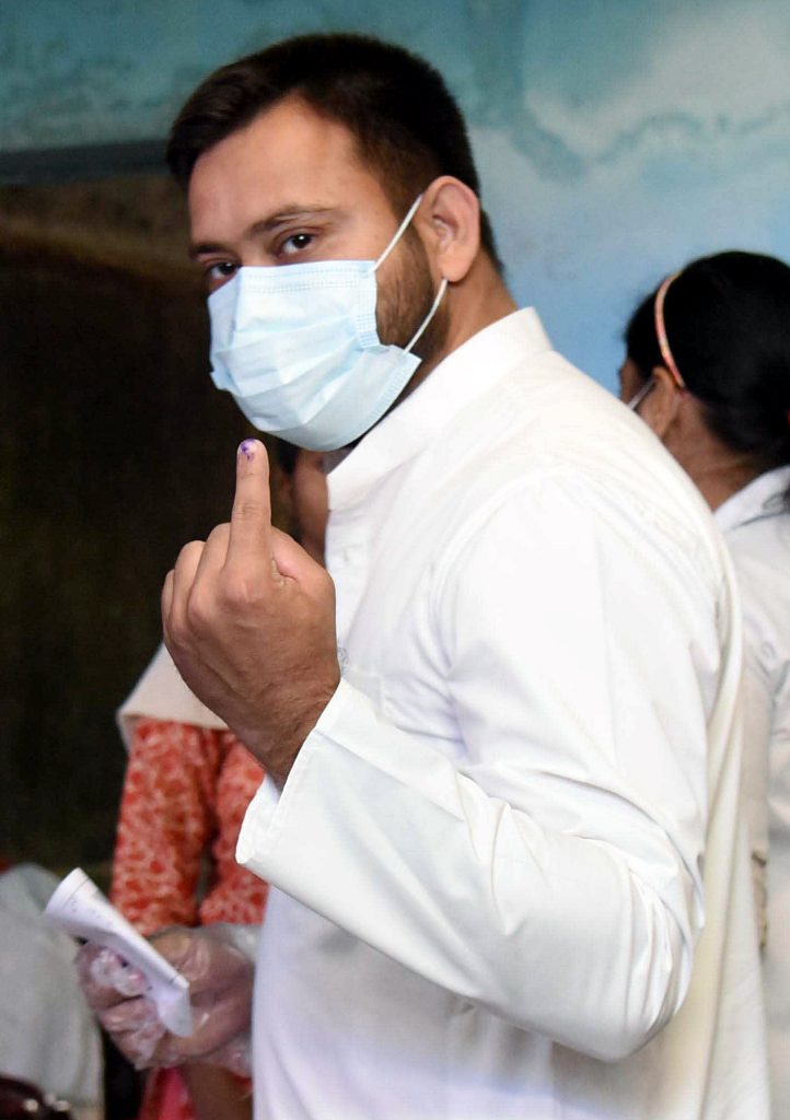 Bihar, Nov 03 (ANI): RJD leader Tejashwi Yadav shows his finger marked with indelible ink after casting a vote for the second phase of the Bihar Assembly Election, amid the coronavirus pandemic, in Patna on Tuesday. (ANI Photo)