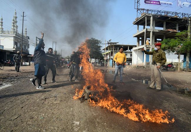 Assam, Dec 08 (ANI): Asom Sankhyalaghu Sangram Parishad supporters burn tyres to block the road in support of the nationwide strike called by Farmers' Unions in Nagaon on Tuesday. (ANI Photo)