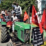Telangana, Dec 08 (ANI): Left parties' supporters drive a tractor in support of the nationwide strike called by Farmers' Unions in Hyderabad on Tuesday. (ANI Photo)