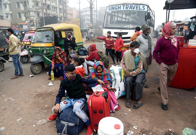 Bihar, Dec 08 (ANI): Passengers wait outside the Mithapur Bus stand during the nationwide strike called by Farmers' Unions in Patna on Tuesday. (ANI Photo)