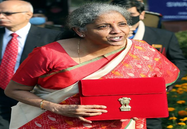 New Delhi, Feb 01 (ANI): Union Minister for Finance and Corporate Affairs, Nirmala Sitharaman shows the Made-in-India tab through which the budget will be presented as she leaves from the Ministry of Finance to present the Union Budget 2021-22 in the Parliament, in New Delhi on Monday.