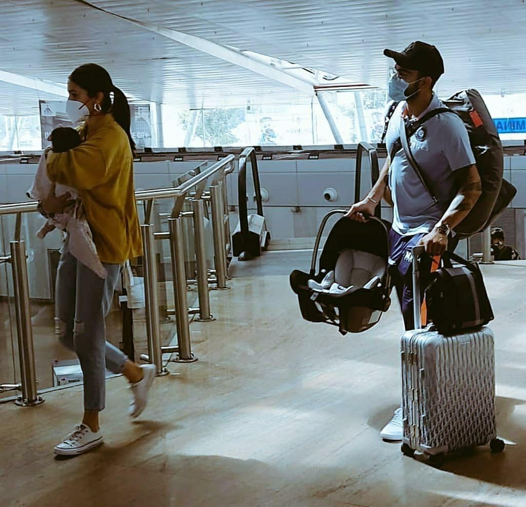 Anushka Sharma holds daughter Vamika as Virat Kohli carries luggage