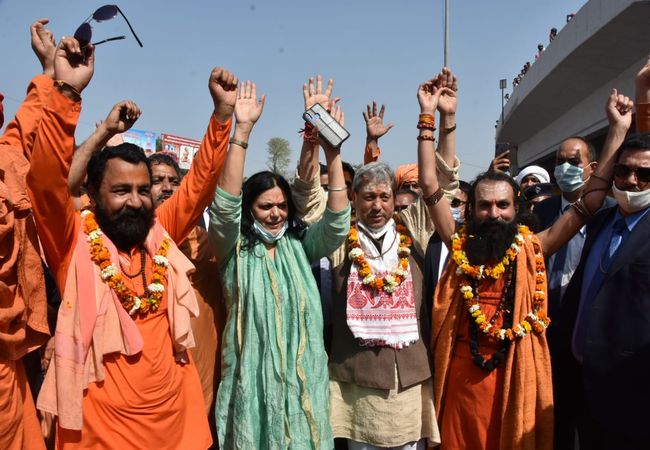Uttarakhand: Chief Minister Tirath Singh Rawat showers flowers on devotees in Haridwar