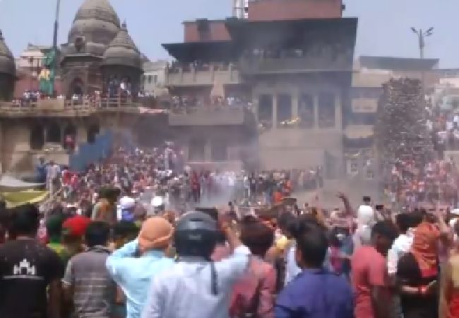 WATCH | People celebrate Holi festival with ashes and ‘gulal’ at Manikarnika Ghat in Varanasi