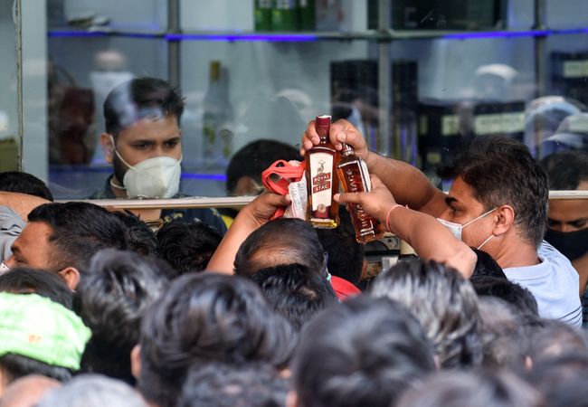 People gather outside liquor shop after delhi govt announces a one-week curfew; See pics