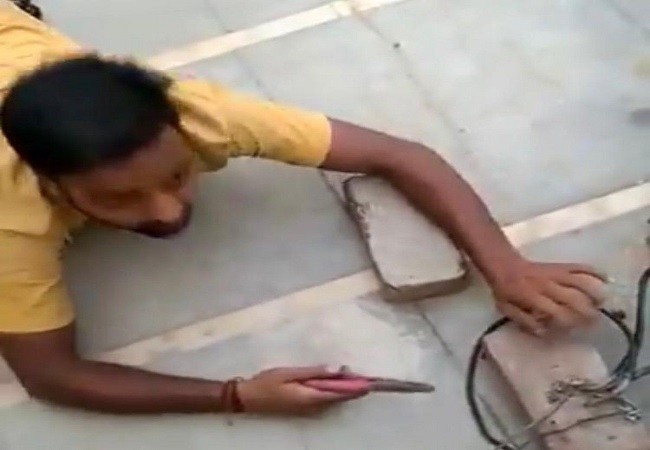 Man crawls like snake to cut illegal electricity connection, caught on CAM; hilarious VIDEO cracks up internet
