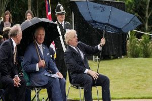 UK PM Boris Johnson struggles to hold umbrella, Prince Charles amused; so is the internet…. WATCH