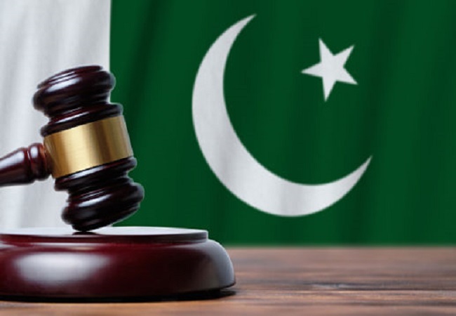 Justice and court concept in Islamic Republic of Pakistan. Judge hammer on a flag background