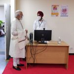 PM Modi interacts with health workers at the vaccination site at RML Hospital