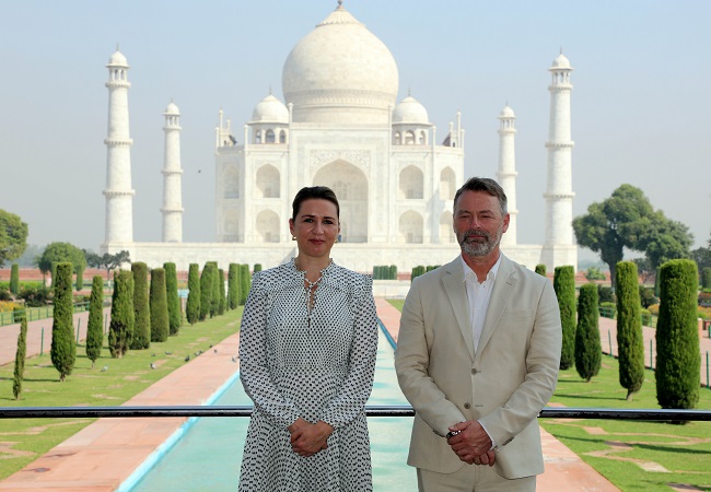 Denmark Prime Minister Mette Frederikse with her husband pose for a photo as they visit Taj Mahal