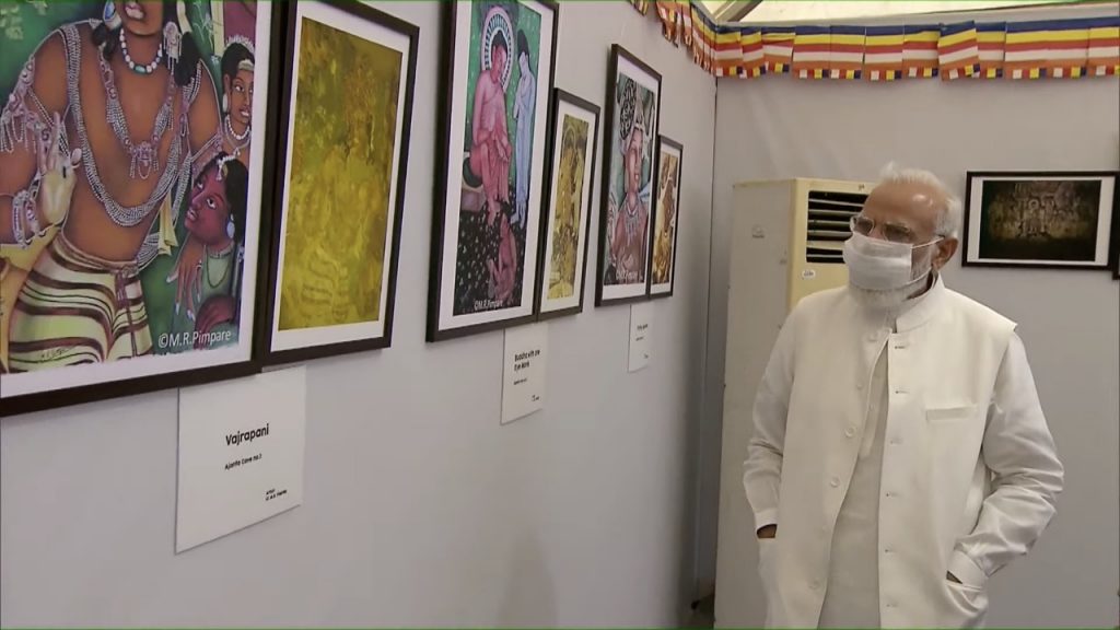 PM Modi walk through the exhibition of paintings of Ajanta frescos, Buddhist Sutra Calligraphy and Buddhist artefacts excavated from Vadnagar and other sites in Gujarat.