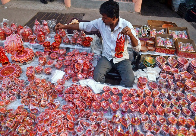 A vendor displays earthen lamps for sale ahead of the Diwali festival