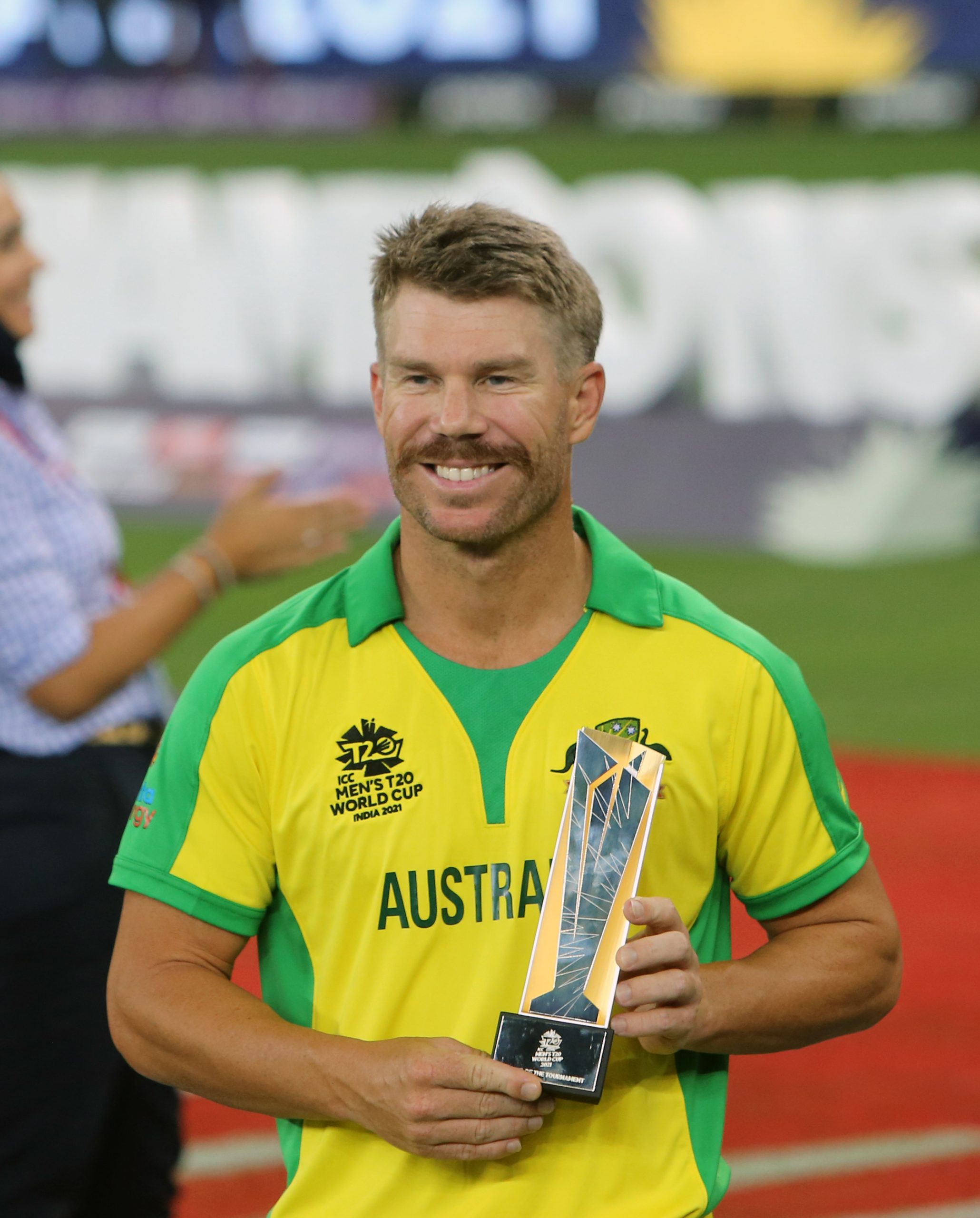 Australia's David Warner receives a player of the tournament award during the ICC Men's T20 World Cup final match against New Zealand