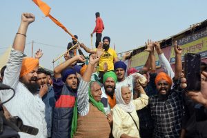 Supporters celebrate after PM Modi announced the repealing of the three farm laws; See Pics