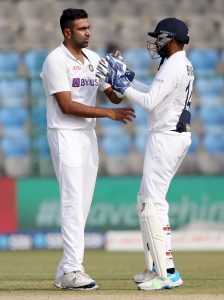 Ravichandran Ashwin of India celebrates the wicket of William Young of New Zealand with KS Bharat