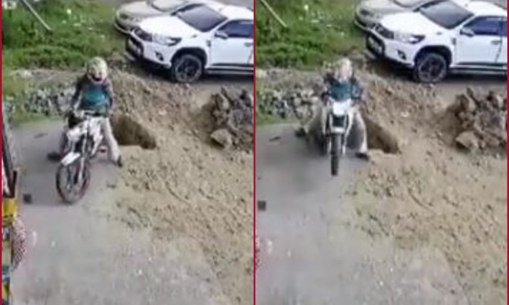 Biker falls into huge pit while reversing two-wheeler; leaves netizens in shock (Watch)