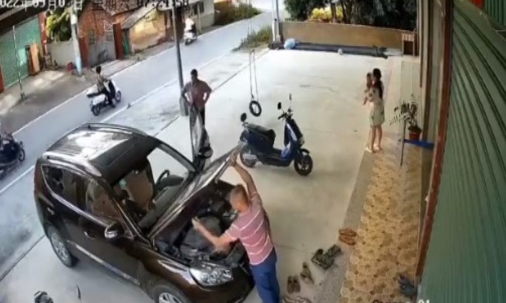 In a tragic video, a man is seen being struck by a wrecked car as he works to fix it