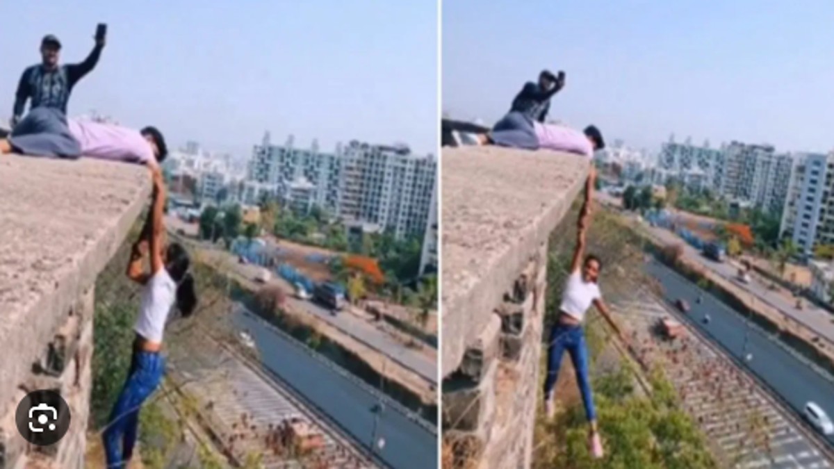 Pune woman hangs from a tall bulding holding man’s hand for making reel